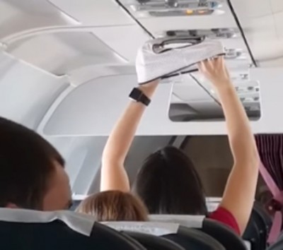 Woman dries underwear under AC vent in packed flight 