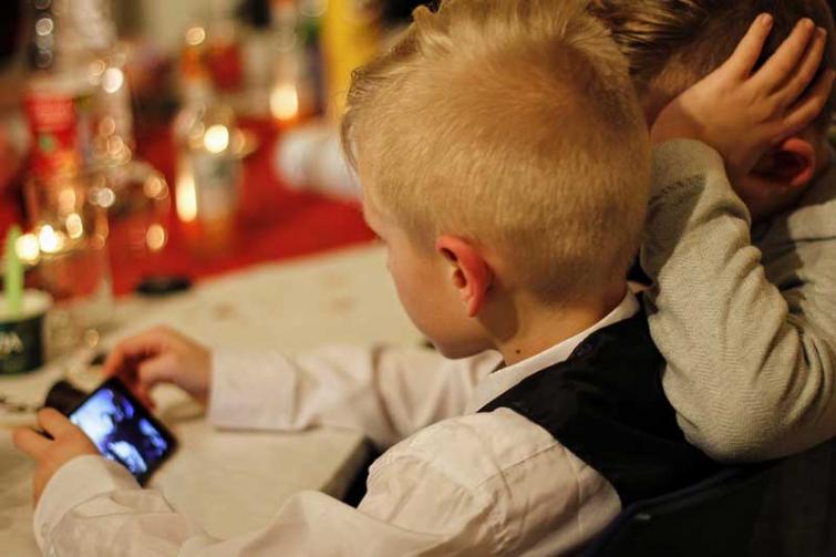 Children looking at screens in darkness before bedtime are at risk of significantly reduced sleep, study finds 