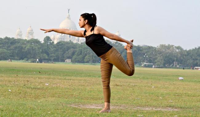 Sudeshna Sen, a 24-year-old student at St. Xavierâ€™s College in Maidan, Kolkata, practices yoga in front of the Victoria Memorial. Sen has been practicing yoga for three years and attends weekend classes at Power Yoga in Kolkata.
