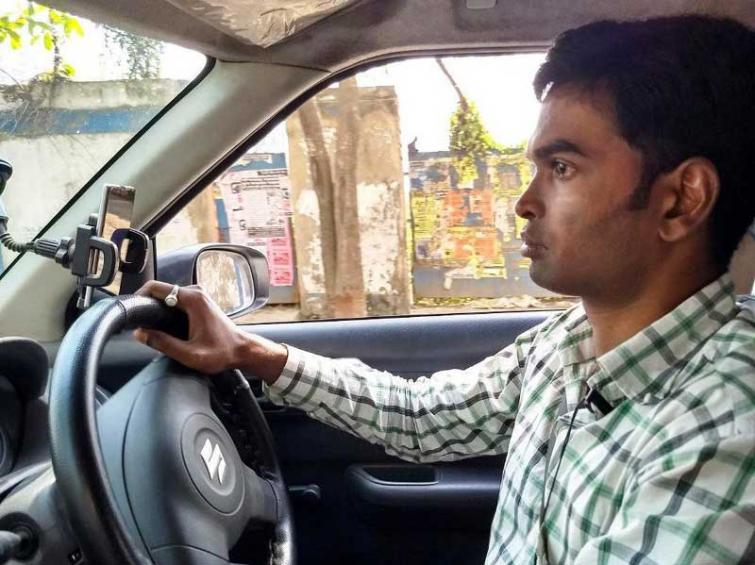 Subhash Mondol, 31, switched from Ola to Uber in Kolkata, India, a year ago because Uber pays him better, he said. He used to drive for traditional yellow cabs, but he started driving for Uber because â€œmore educatedâ€ people opt Uber, he said. (Photo by Suryodoy Mondol)