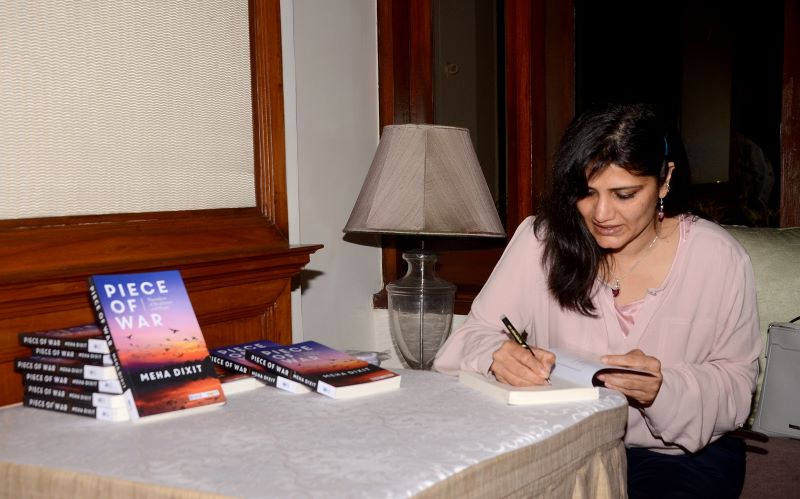Meha Dixit signing her book for guests (Image Credit: Avishek Mitra/IBNS)