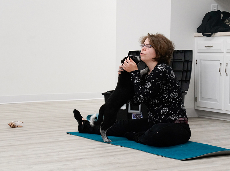 Yoga instructor Sarah Judd teaches her class while a puppy attempts to interrupt on Saturday, Apr. 8, 2023, at Selfie Love in Columbia. The class was a collaboration between Selfie Love, Sarah