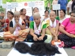 To secure indigenous peopleâ€™s rights women activists stage protest by shaving off head in Guwahati