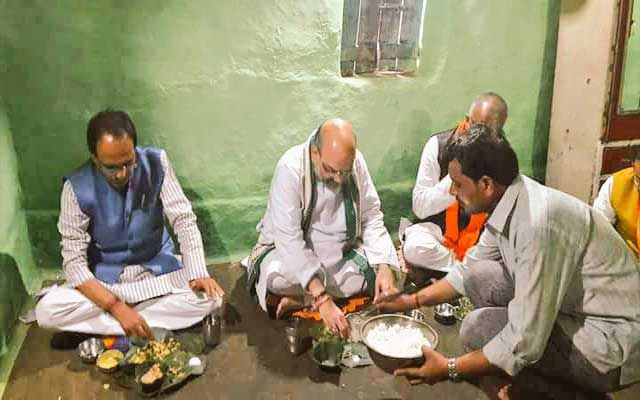Amit Shah eats food at tribal's house in Madhya Pradesh