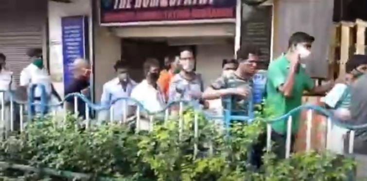 Indians queue up outside liquor shops as stores open, flout social distancing norms