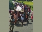 Assam villagers conduct last rites of a bull with kirtan, procession