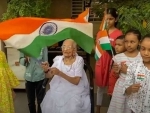 PM Modi's mother distributes national flags in her Gandhinagar residence