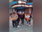 'Overseas Friends Of Ram Mandir' members distribute laddoos at Times Square ahead of consecration ceremony of Ram Temple in Ayodhya