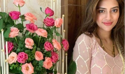 With a bouquet of rose by her side, Nusrat Jahan looks gorgeous in her latest Instagram photo