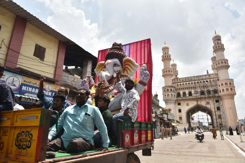 Hyderabad: Devotees on a truck passing through Charminar
