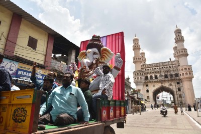 Hyderabad: Devotees on a truck passing through Charminar
