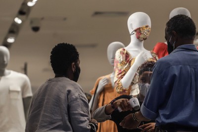 Consumers get their temperature checked at a store entrance in Brazil's San Paulo