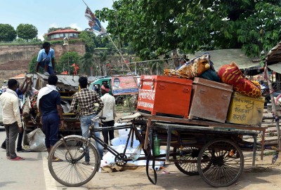 People shifting their belongings after Ganges water level rose in UP's Prayagraj