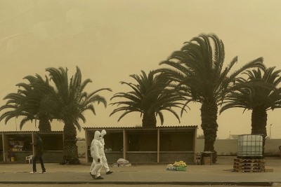 Namibia: Epidemic prevention personnel walk in sandstorm in Walvis Bay