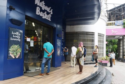 People lines up for essentials at Park Street in Kolkata