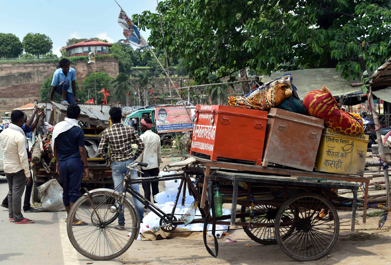 People shifting their belongings after Ganges water level rose in UP's Prayagraj
