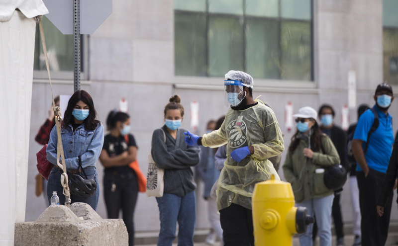 Security officer maintaining order outside a COVID-19 test center in Toronto, Canada