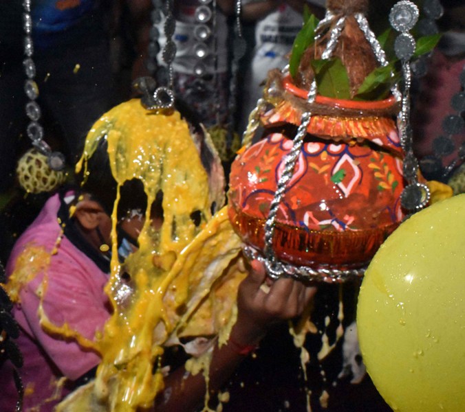 Boy wearing mask breaks earthen pot to mark Janmashtami
