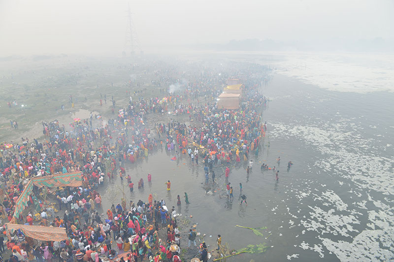 Devotees worship the rising sun at the banks of Yamuna in Delhi