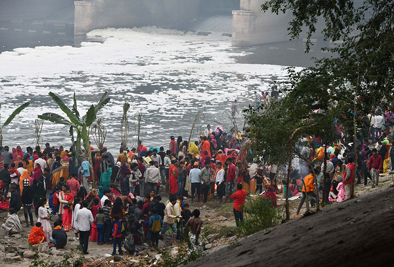 Devotees worship the rising sun at the banks of Yamuna in Delhi