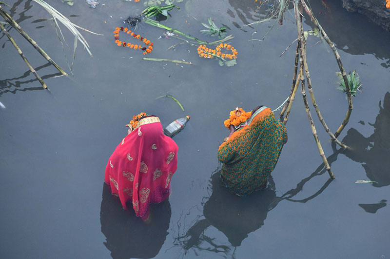Devotees worship the rising sun at the banks of Yamuna in Delhi