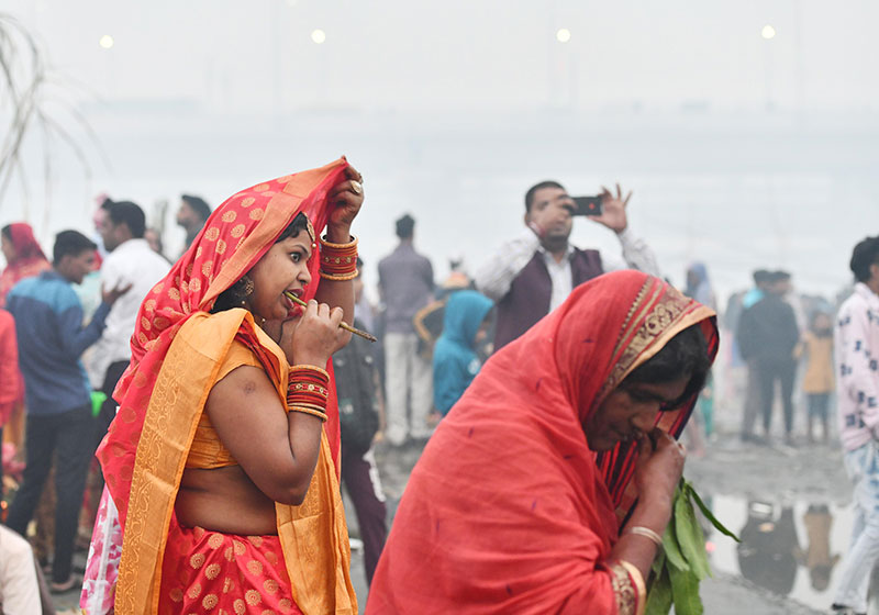 Devotees worship the rising sun at the banks of Yamuna in Delhi