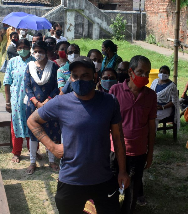 Voters waiting in queue at Thakurpukur polling station in Kolkata during Bengal Assembly Elections