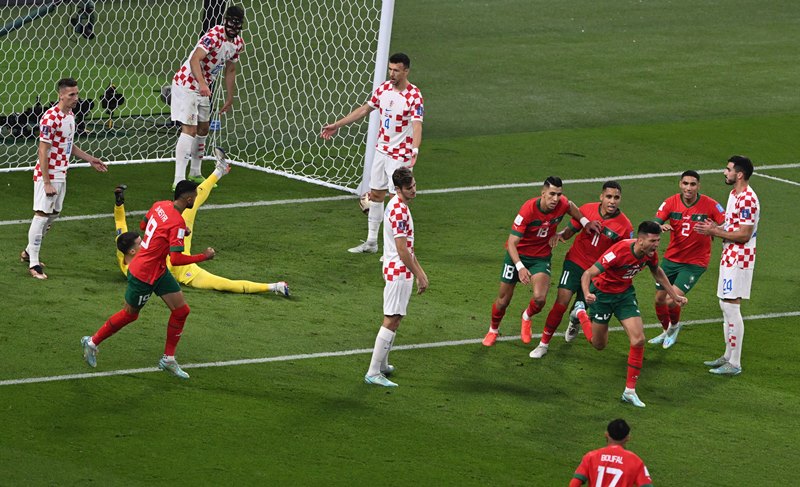 Achraf Dari of Morocco celebrates his goal with teammates during third place play-off match