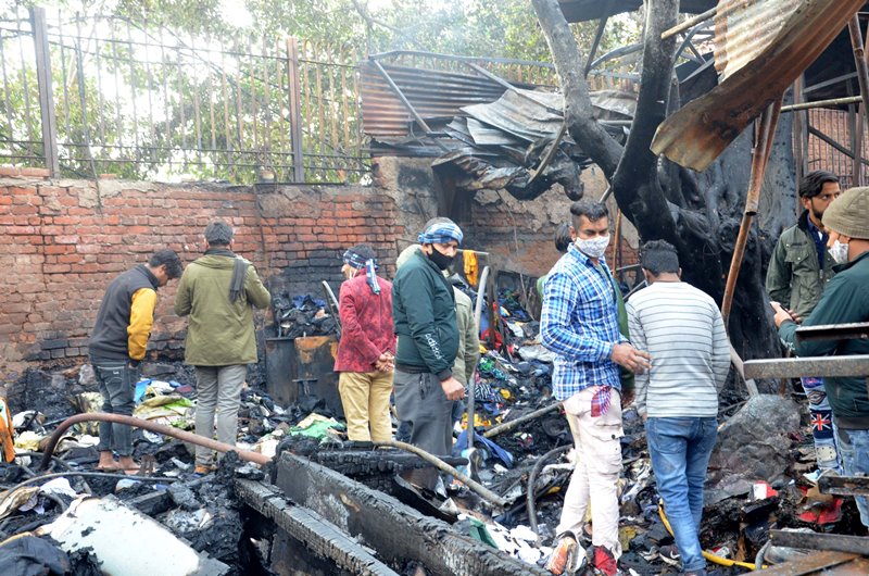 Firefighters extinguishing fire at Delhi's Lajpat Rai market