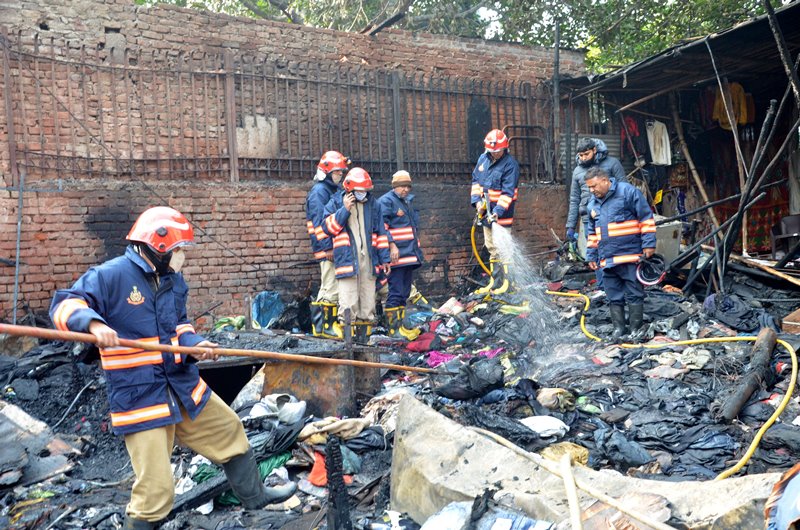 Firefighters extinguishing fire at Delhi's Lajpat Rai market