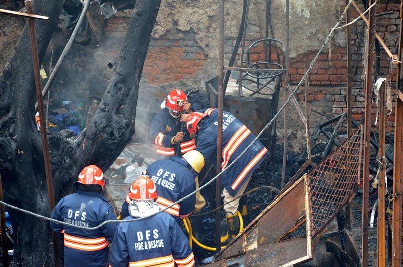 Firefighters extinguishing fire at Delhi's Lajpat Rai market