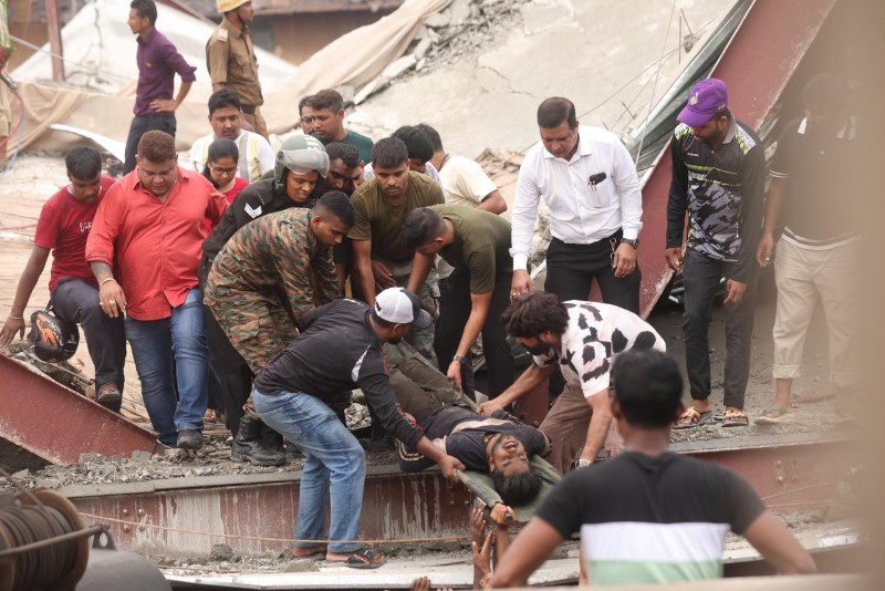Rescuers race against time as trapped workers remain beneath collapsed Taratala warehouse structure.