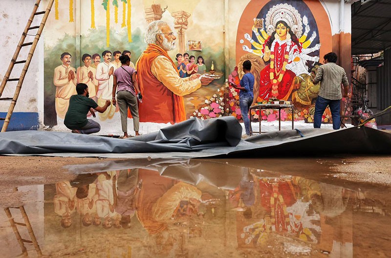 In Images: Kolkata’s Chorebagan Sarbojonin unveils wall painting of PM Modi performing aarti to Goddess Durga