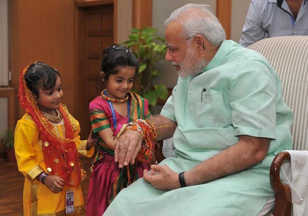 Women, children tie Rakhi on PM's wrist on Raksha Bandhan