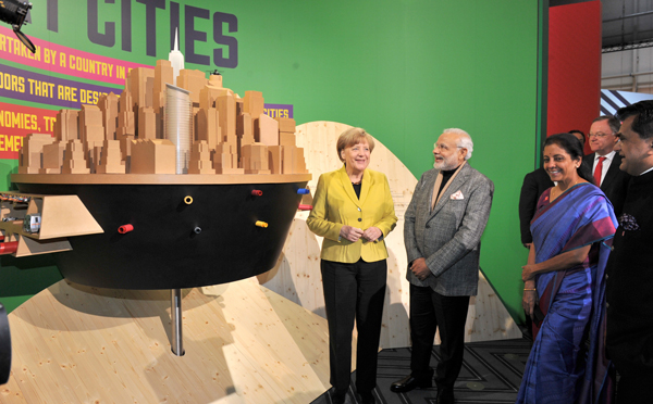 Modi and the German Chancellor, Ms. Angela Merkel at the Joint Inauguration of the India Pavilion and the Joint Walk-About Make in India
