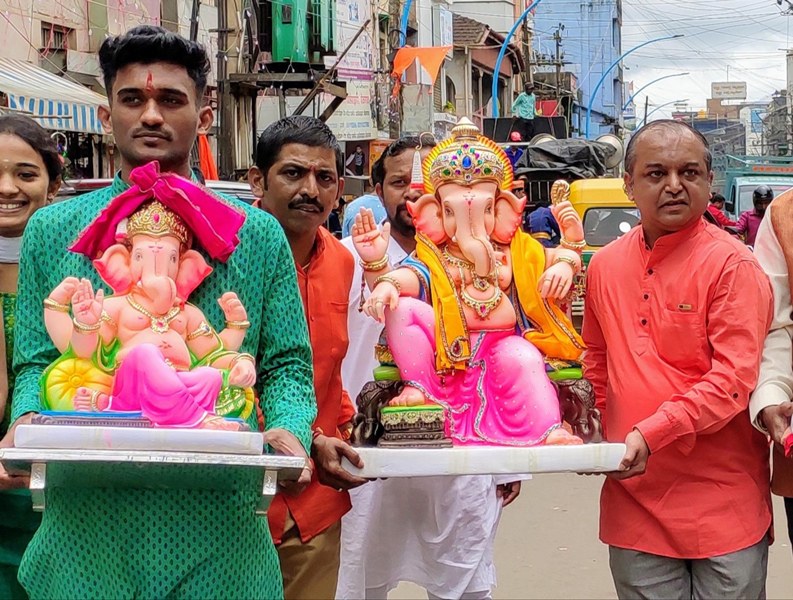 People carry Lord Ganesh to their home on Ganesha Chaturthi