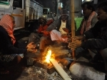 People warm up before fire to fight cold in Kolkata 
