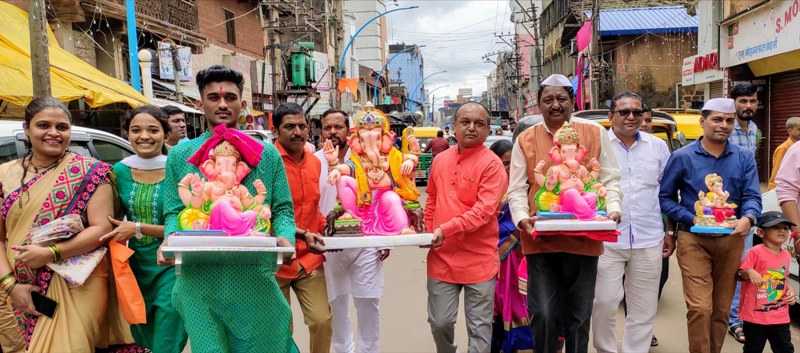 People carry Lord Ganesh to their home on Ganesha Chaturthi