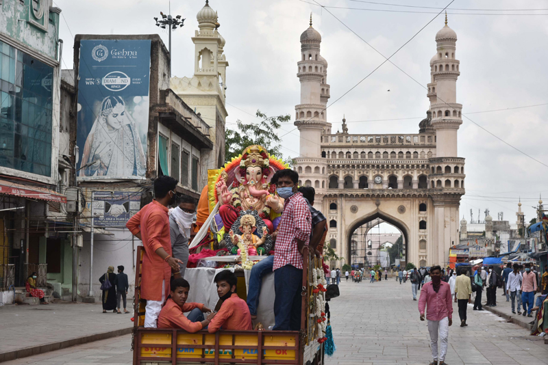 Hyderabad: Devotees on a truck passing through Charminar