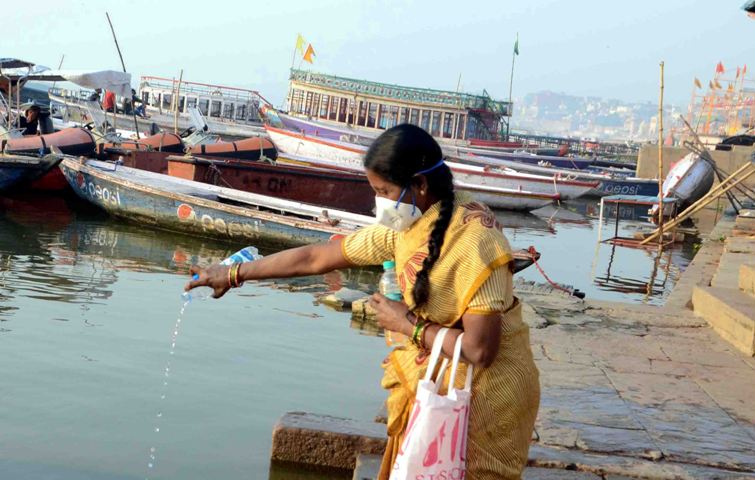 Woman offers obeisance to Ganges in locked down Varanasi