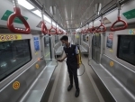 Lucknow Metro employee sprays disinfectants inside coaches at Hazratganj station
