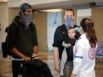 Israeli medical worker checks temperature passengers