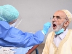 Morocco: A medical worker collects a swab from a man for a COVID-19 test