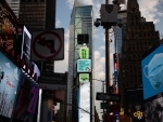 Billboards at Times Square in New York encourage people to maintain social distancing