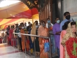 Patna: People wait to enter Mahavir Temple