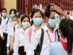 Students queue for body temperature screening at the Bak Touk High School in Phnom Penh