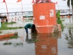 Man drinks water from submerged floodwater of Ganga in Prayagraj