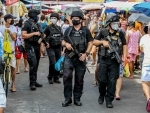 Members of the Special Weapons and Tactics of the Philippine National Police (PNP-SWAT) patrol a market