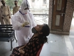 Health staff taking nasal swab on woman in Jammu