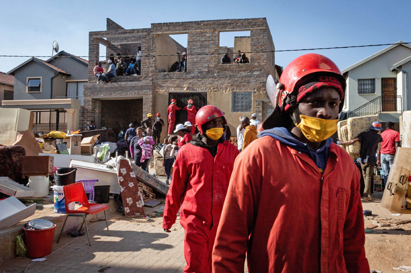 Staff members of moving company Red Ants are seen at work in Johannesburg